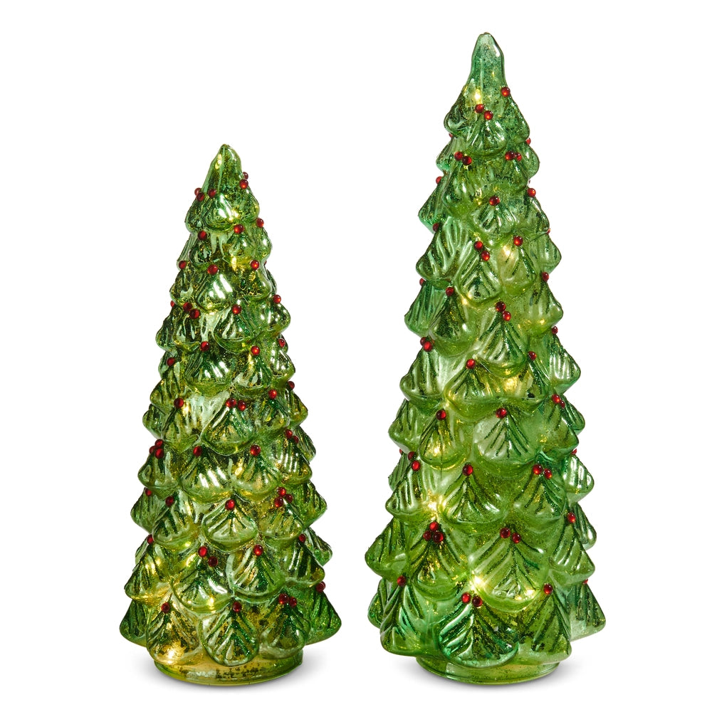 Two green ceramic Christmas trees with red berries on a white background