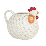 Ceramic chicken-shaped creamer with a red comb on a white background