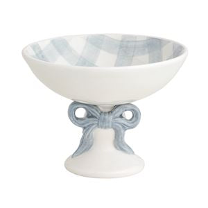 Decorative ceramic bowl with blue and white checkered interior and bow design on stand.
