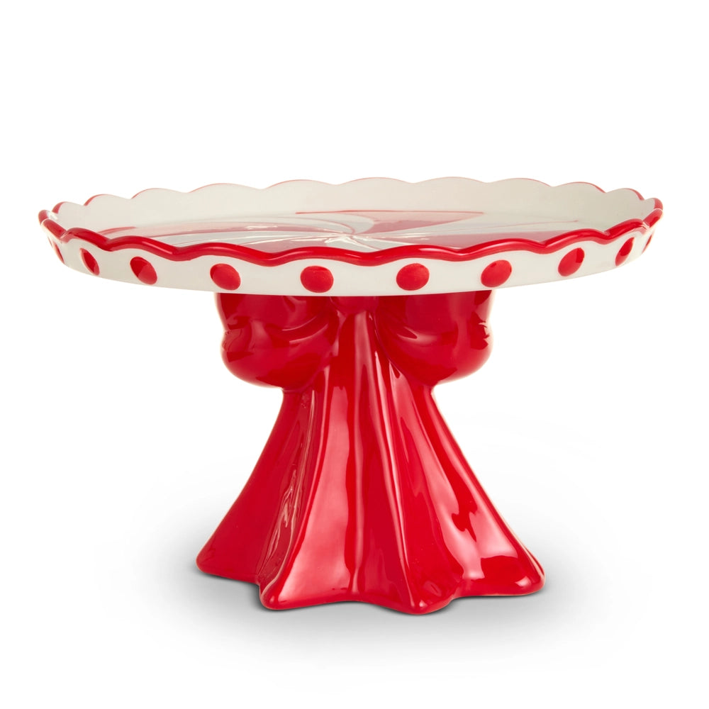 Red and white ceramic cake stand with scalloped edge on a white background