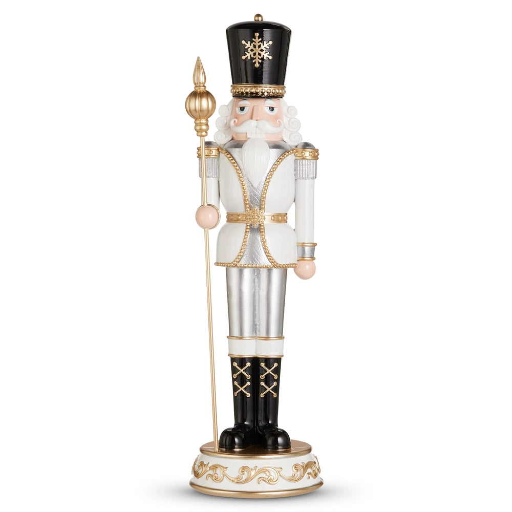 Decorative nutcracker figure with a white beard, black hat, and gold accents on a white background