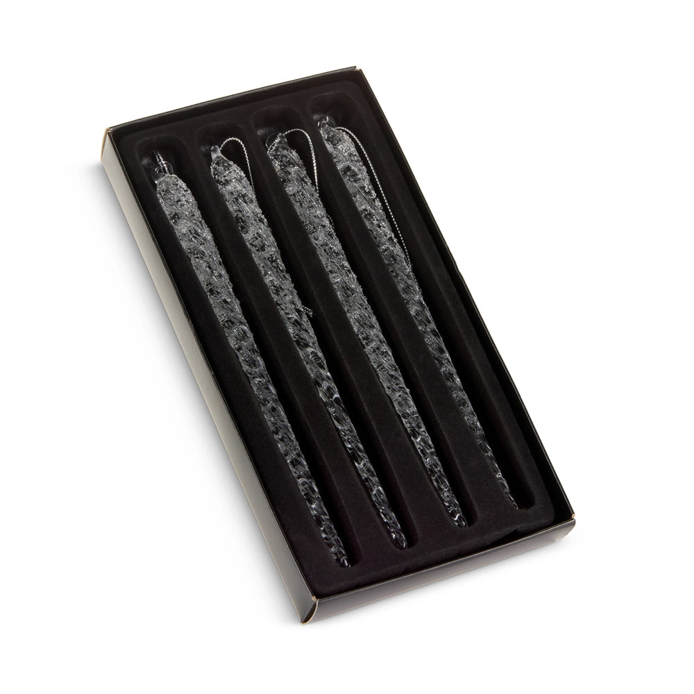 Set of three decorative candles in a black box on a white background