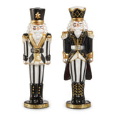 Two decorative nutcrackers in black, white, and gold on a white background