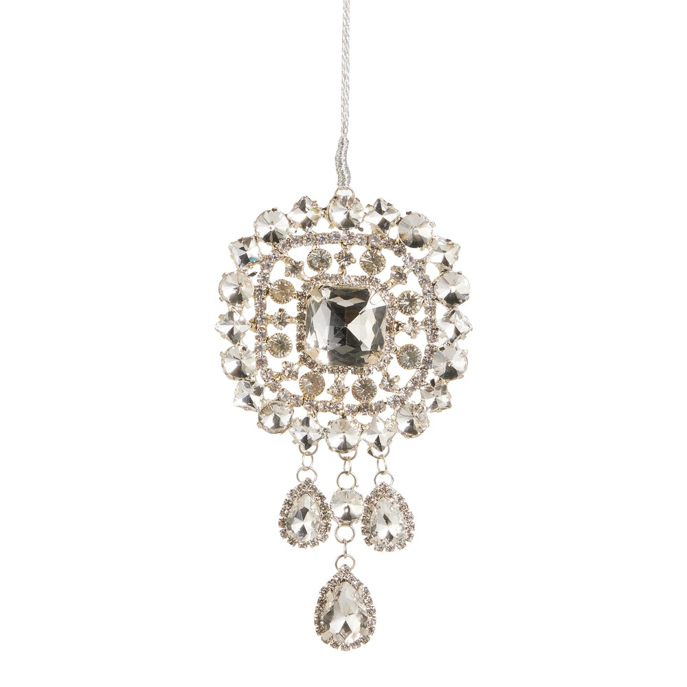 A silver-toned tassel pendant ornament embellished with clear rhinestones and featuring three dangling teardrop-shaped clear crystals, suspended against a plain white background.