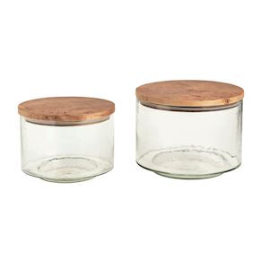 Two glass jars with wooden lids on a white background