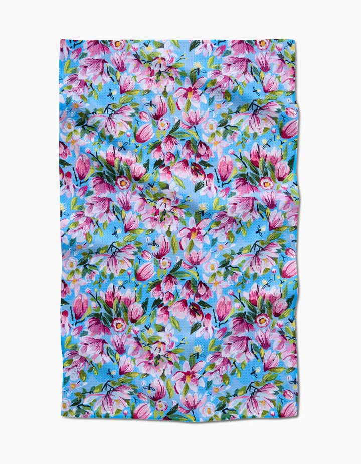 Floral patterned fabric with pink and purple flowers on a blue background