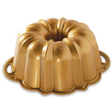 Gold Bundt cake pan on a white background
