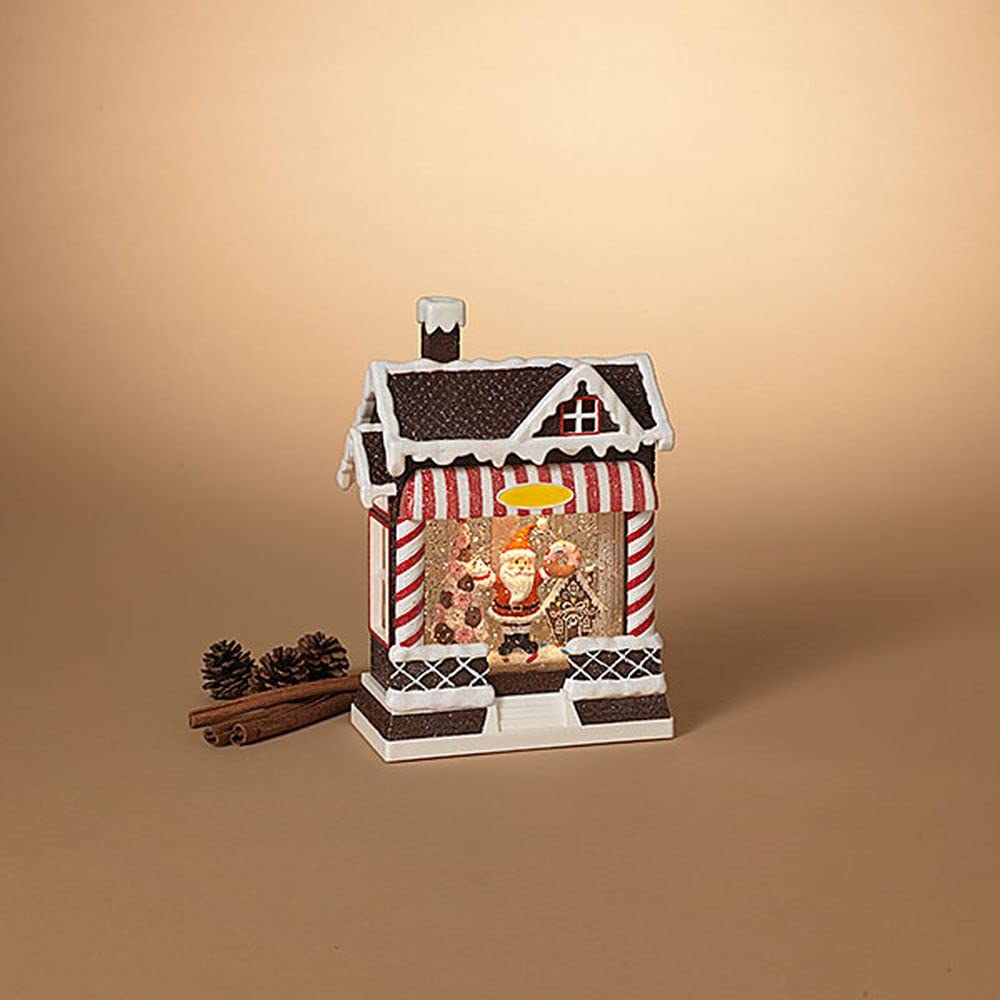 Decorative house-shaped lantern with Santa Claus figure on a beige background