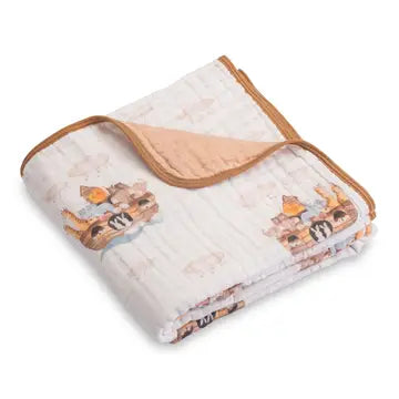 Folded blanket with cartoon cat design on a white background