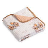 Folded blanket with cartoon cat design on a white background