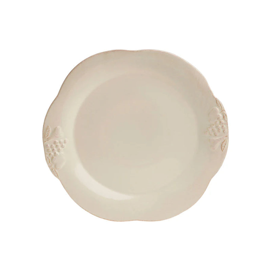 Beige ceramic plate with decorative edge on a white background