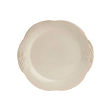 Beige ceramic plate with decorative edge on a white background