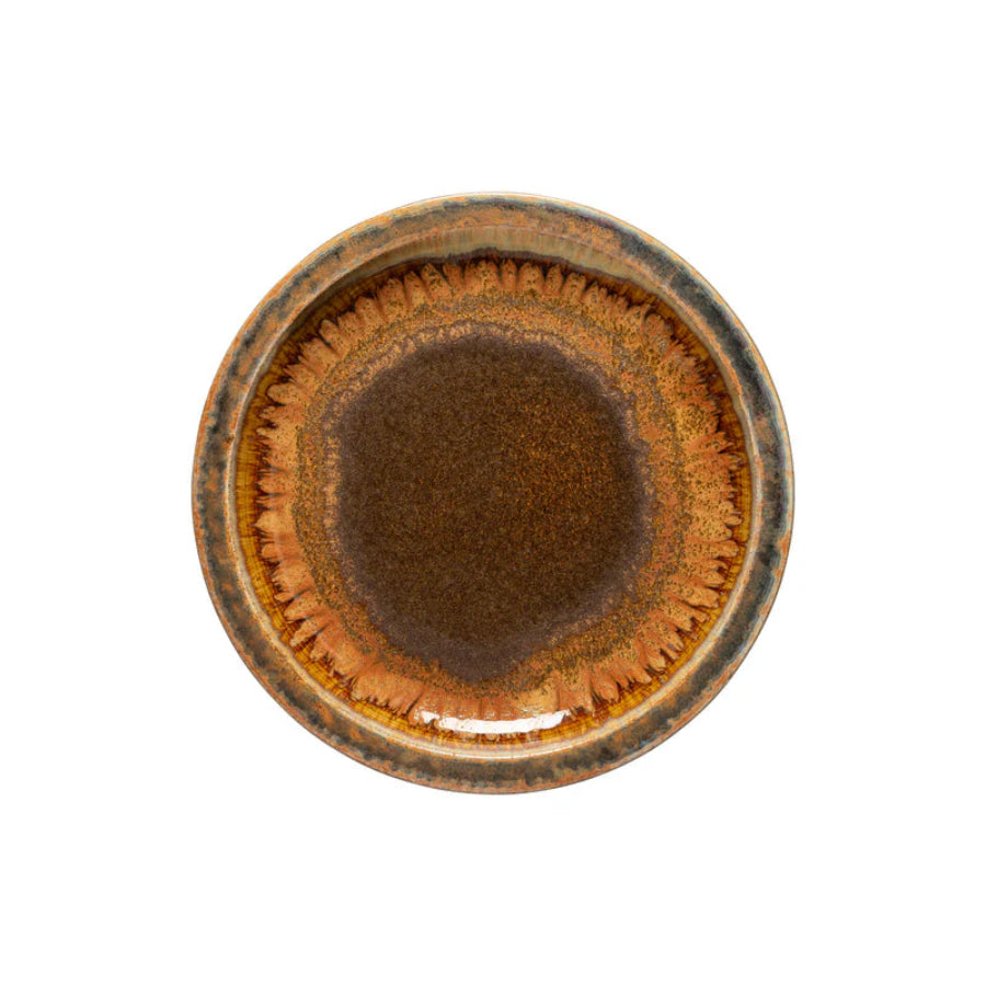 Round ceramic dish with brown glaze on a white background