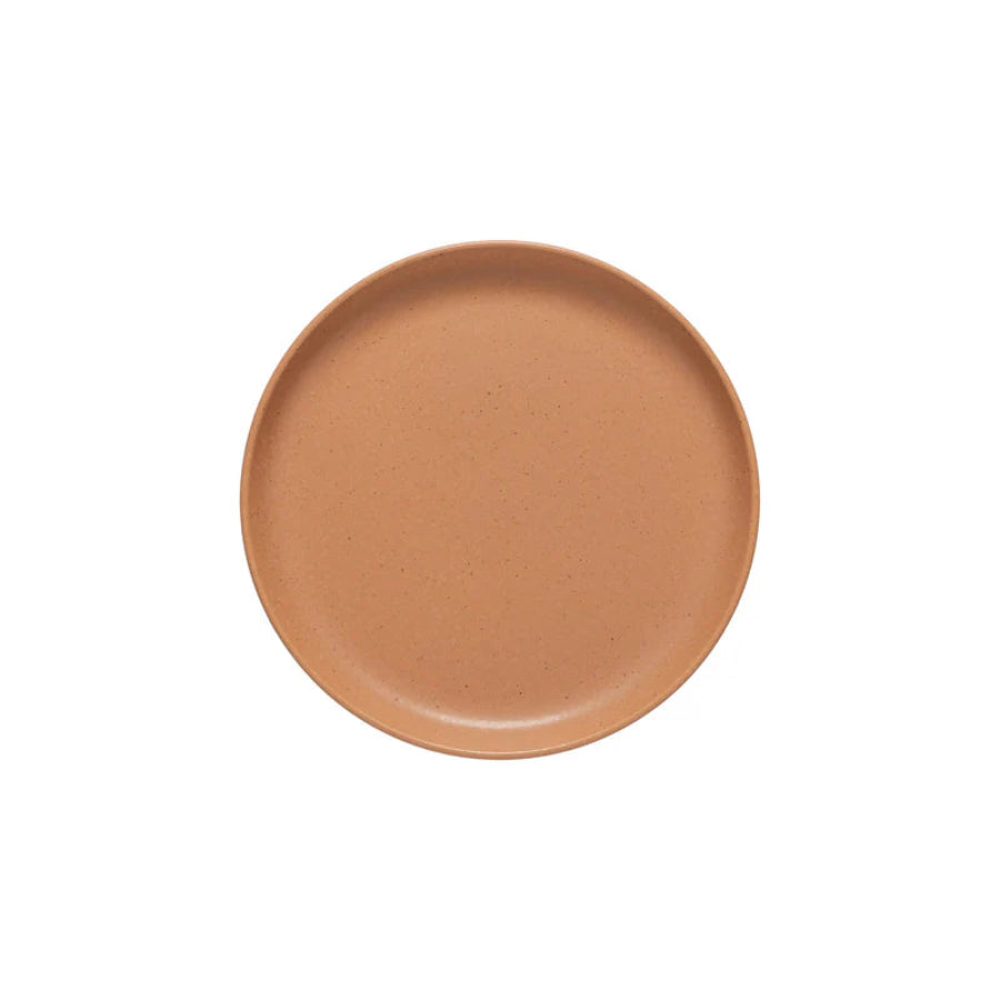 Ceramic plate with a speckled brown design on a white background