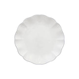White ceramic plate with scalloped edge on a white background