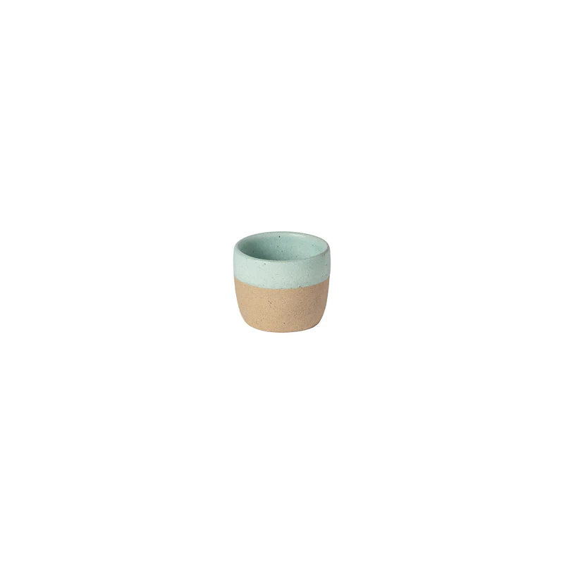 Two-toned ceramic cup with green top and beige bottom on a white background