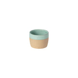 Two-toned ceramic cup with green top and beige bottom on a white background
