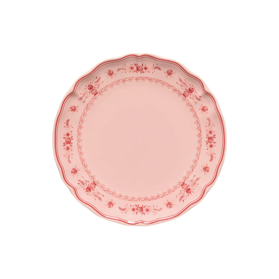 Pink decorative plate with floral patterns on a white background