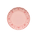 Pink decorative plate with floral patterns on a white background