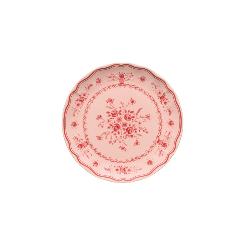 Decorative pink plate with floral patterns on a white background