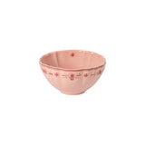 Pink ceramic bowl with floral patterns on a white background