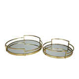 Two round glass trays with gold metal frames on a white background