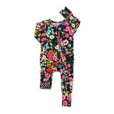 Floral-patterned baby romper with matching headband on a white background