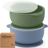 Two silicone bowls, one green and one blue, with a lid and packaging on a white background.