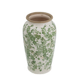 Ceramic vase with green floral pattern on a white background