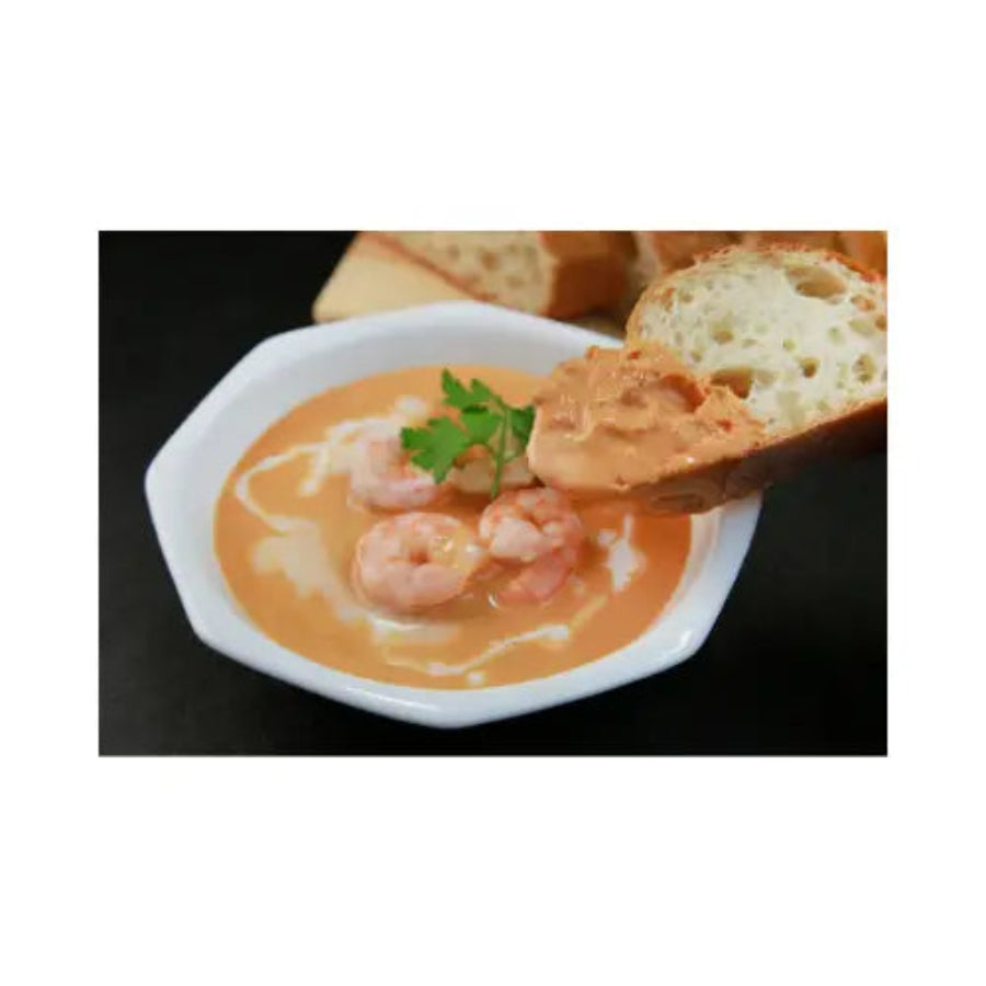soup with shrimp and bread in a white bowl