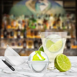 Glass with lime slices on a bar counter, featuring a cocktail shaker and limes.