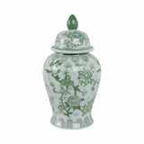 Decorative ceramic jar with green floral patterns on a white background