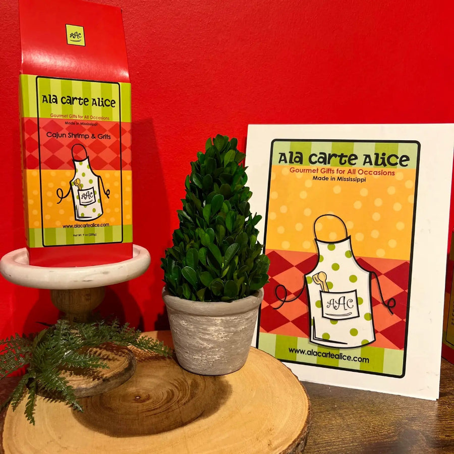 Ala carte Alice packaging with a plant and wooden board against a red wall