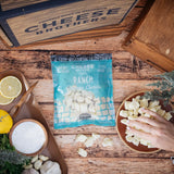 Packaged ranch cheese cards with 'Cheese Brothers' branding on a wooden surface.