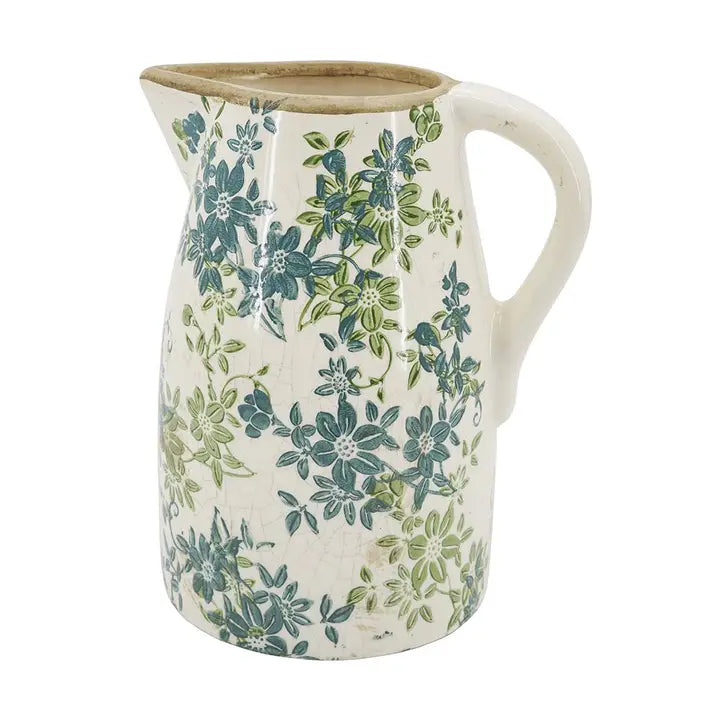 Ceramic pitcher with floral pattern on a white background