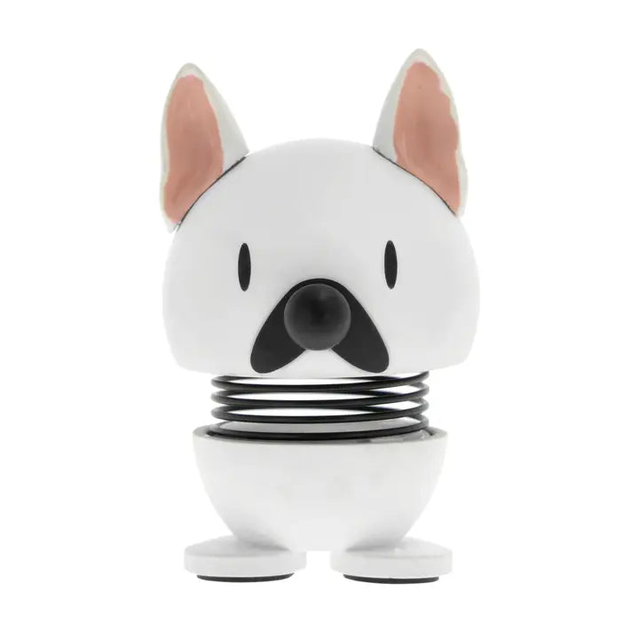 White dog-shaped product with a black spring on a white background
