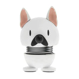 White dog-shaped product with a black spring on a white background