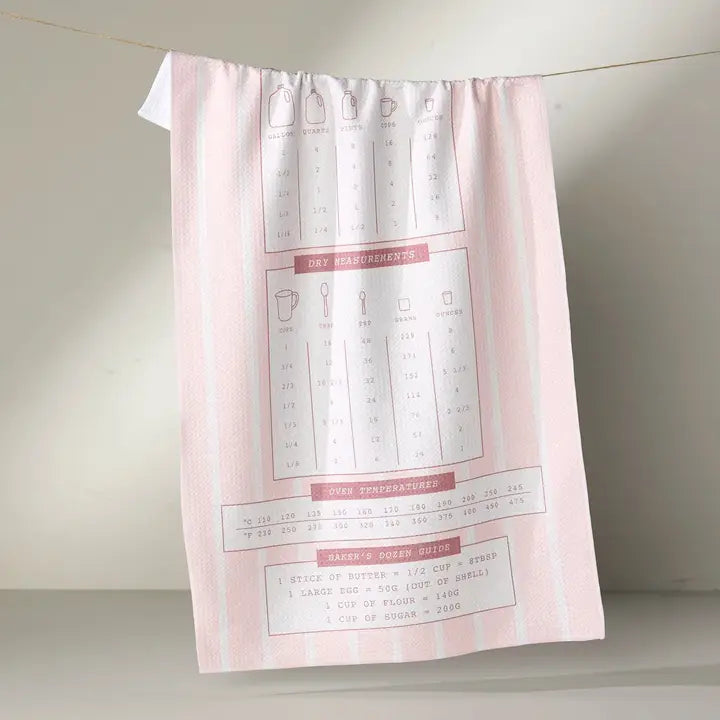 Pink kitchen towel with recipe illustrations on a white background