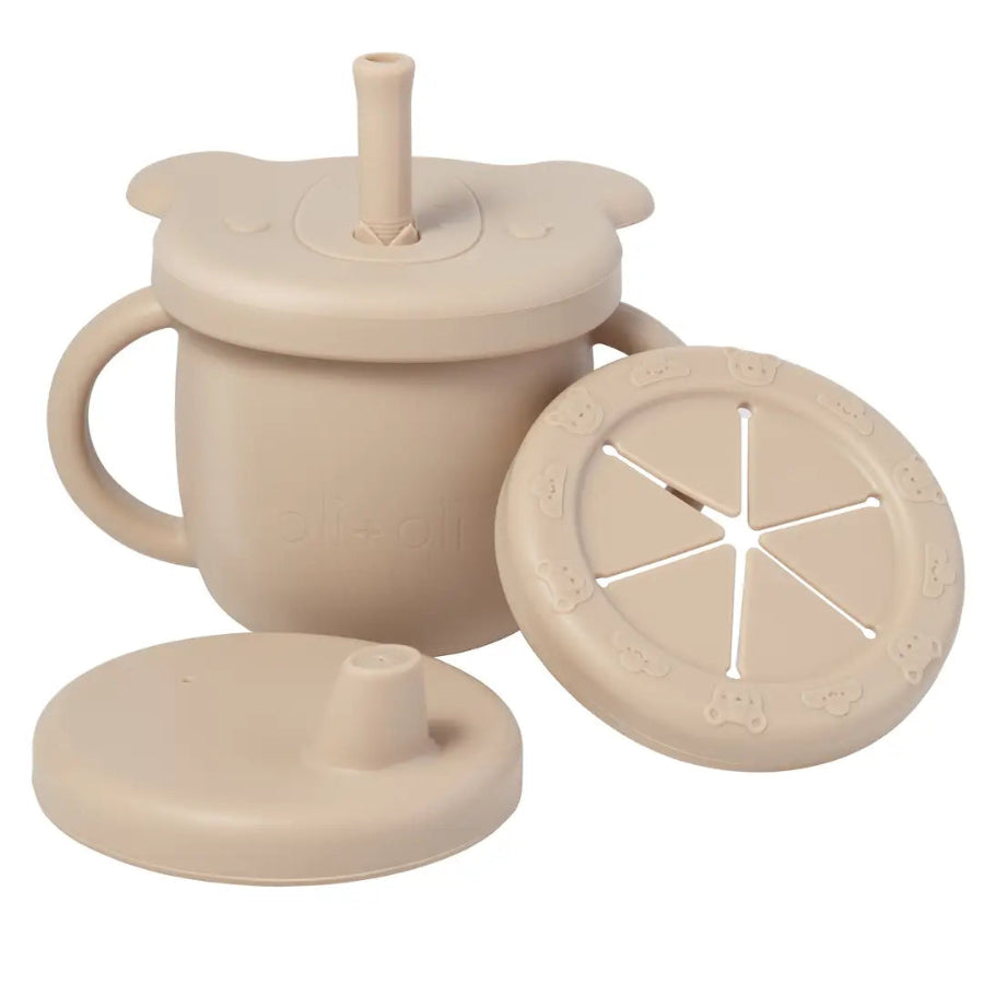 Beige silicone cup with lid and straw, and a separate lemon-shaped component on a white background