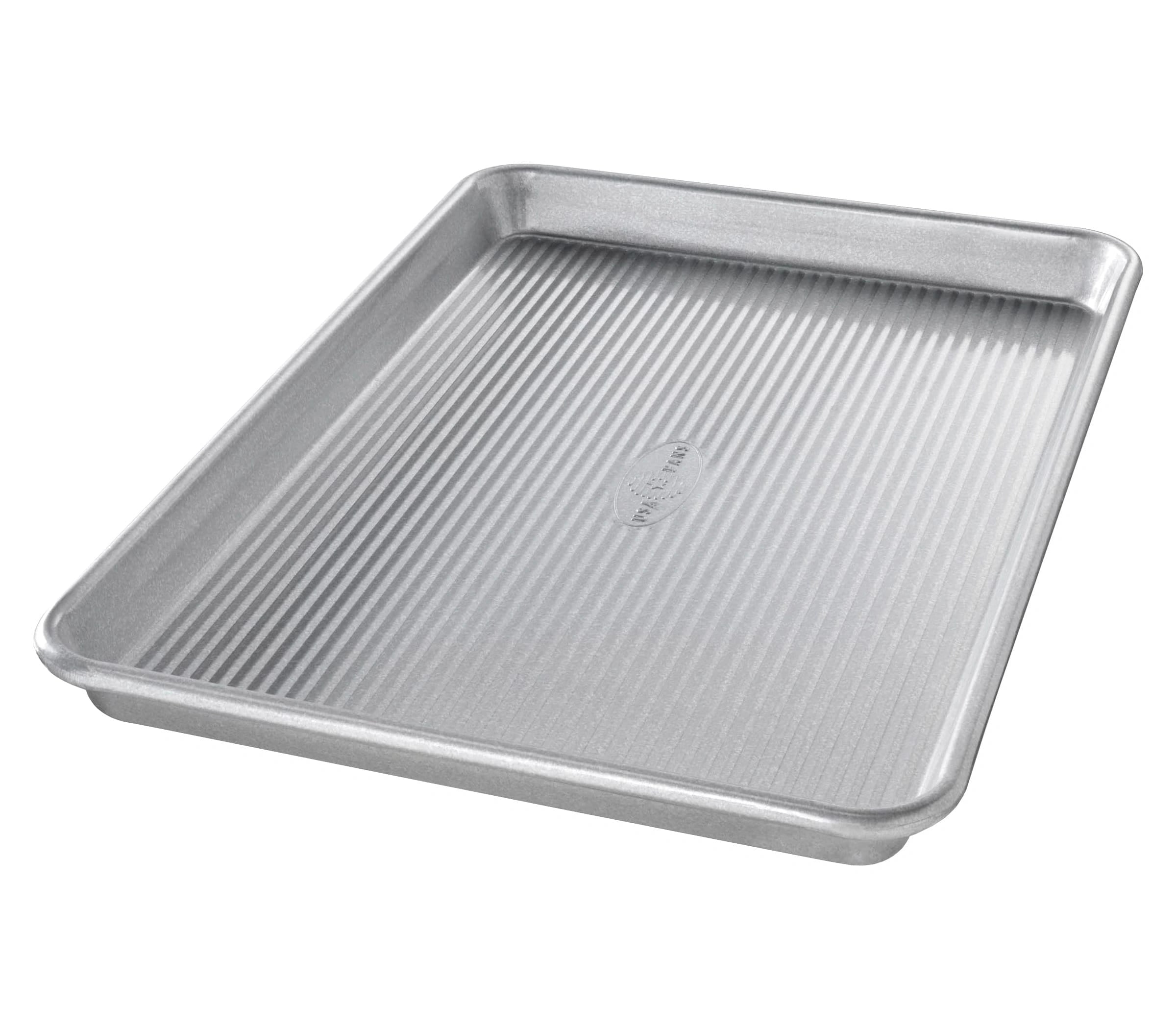 Metal baking tray with ribbed surface on a white background