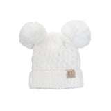 White knit baby hat with pom-poms on a white background