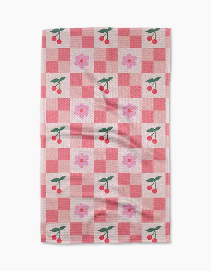 Checkered towel with cherry and flower pattern on a white background
