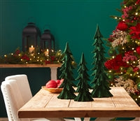 Decorative Christmas scene with small trees on a table against a festive background.