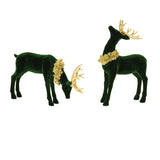 Two green deer figurines with gold antlers and wreaths on a white background