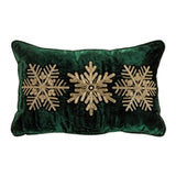 Green pillow with gold snowflake patterns on a white background