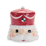 Ceramic cookie jar shaped like a face with a red hat on a white background
