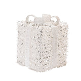White textured handbag with decorative handles on a white background