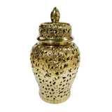 Gold decorative urn with intricate patterns on a white background