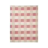 A rectangular woven textile with a pink and cream gingham check pattern, shown flat against a plain white background.