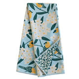 Folded towel with floral and bird pattern on a white background